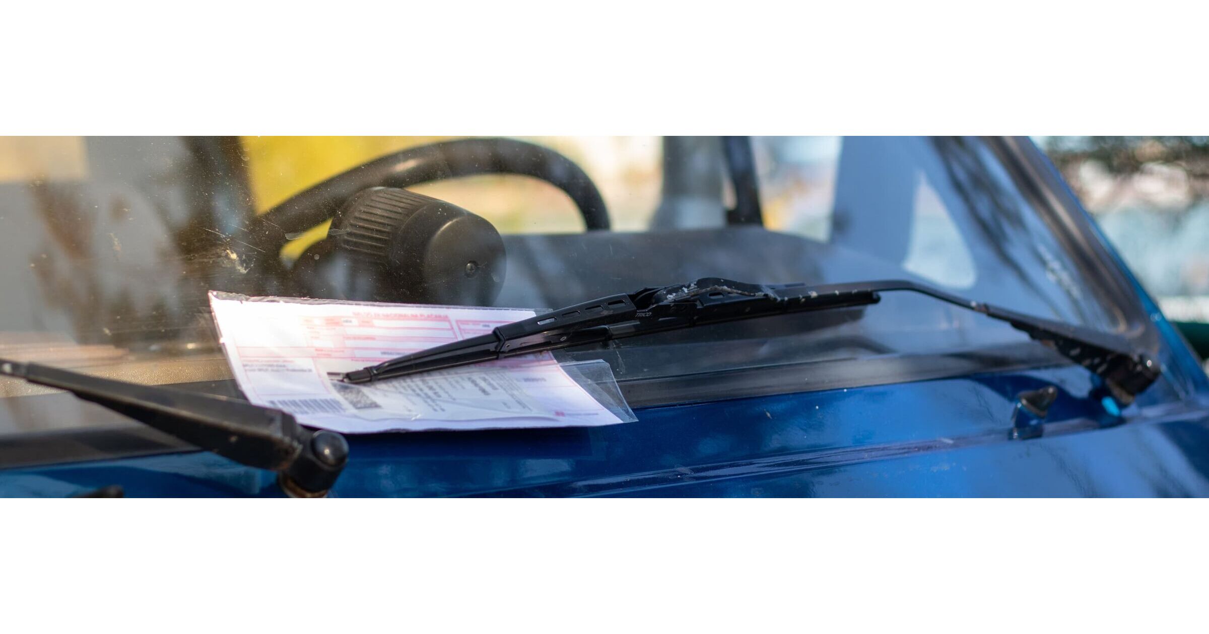 What happens if I get a parking or speeding fine in a hire car?